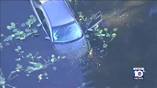 Worker rescues woman out of submerged car in Weston