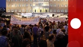 Protesters vent their anger as Greek parliament approves job-cutting bill