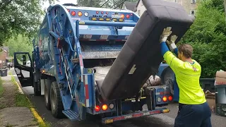 Republic Services Mack LR Mcneilus rear loader garbage truck on a residential trash route.