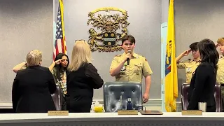 Boy Scout Charley Baird-Hassell sings the National Anthem at Council Meeting