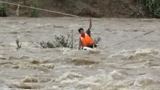 Firefighters, Villagers Rescue Man Trapped in Rushing Flood Water