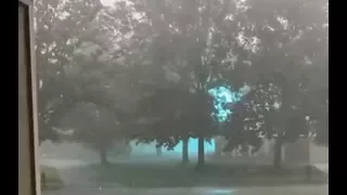 Glowing Blue Ionized Energy Arching Across a Power Line During a Storm