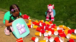 Sofia Plays With Colored Cups and Ride On Сhildren's Сar