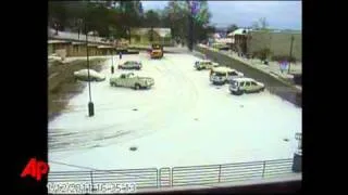 Raw Video: Snowplow Falls Into Parking Lot Hole