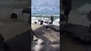 person tries to drive car across beach…