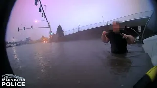 Body camera footage shows officers rescuing woman and young child as water quickly rises around van