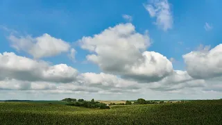 Timelapse of clouds over the field in summer.