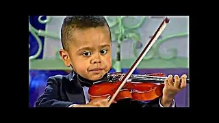 Andre Rieu introduces 3-year-old violinist Akim Camara during his 'Flying Dutchman Concert' in 2004