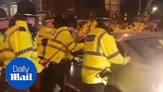 Dangerous driver tries to force way through wall of police