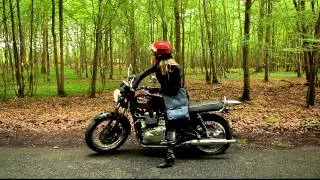 girl in leather ride on flat tire on Triumph Bonneville