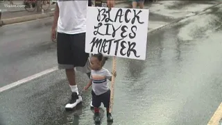 Child holds 'Black Lives Matter' sign at Atlanta protest