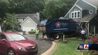 Garbage truck slams into home, damages several cars in Greensboro neighborhood