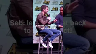 Sebastian Stan falling off his chair and then cringing afterwards.
