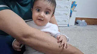 A 5-month-old child playing with his father