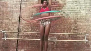 Woman Hula-Hoops Wearing High Heels Using Multiple Hoops - 1062382-1