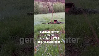 german hunter with his rifle anschutz 1782 8x57 IS suppressor is shooting