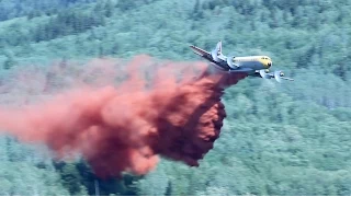 Lockheed Electra L-188 Air Tanker Battles Forest Fire in Northern British Columbia - Stock Footage