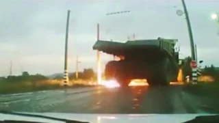 Large Dump Truck drives into high voltage power line, and tires explode.