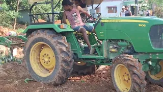 land ploughing  with johndeere  cultivator