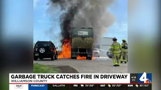 Garbage truck catches fire in driveway