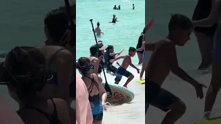 Yikes!!! Shark spotted swimming among people in the water in Navarre Beach, Florida