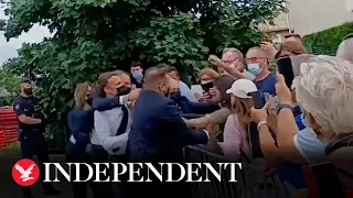 French president Emmanuel Macron slapped in face during visit to town