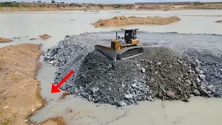 The Best Techniques Build Road Restrict land boundaries by Operator Bulldozer Pushing Stone in Water