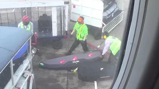 surfboards thrown by baggage controllers