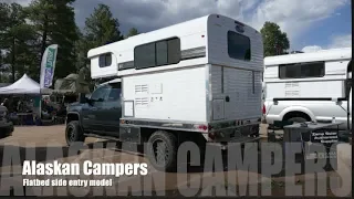 Pop up hard side camper on a flatbed with side entry by Alaskan Campers