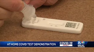 Nurse demonstrates how to take at-home COVID-19 test