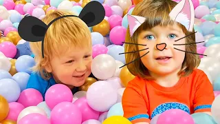 Kids playing on an indoor playground, toy slide, and ball pit for kids. Kid-friendly & family fun.