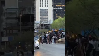 Group jumps on vehicle in downtown Chicago