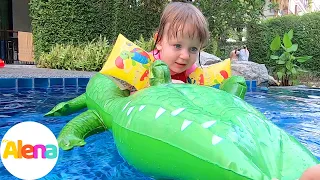 Alena swims and plays in the children's pool. Float on the mattress. Videos for children