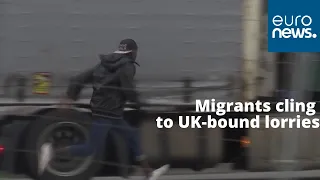 Migrants cling to UK-bound lorries