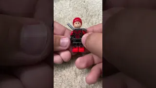 Putting a red beanie on my Deadpool Minifig as his mask￼. #ASMR￼￼
