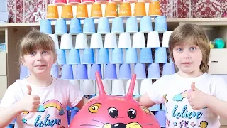 Liza and Katy play with  colorful  cups .