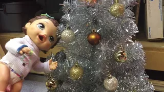 Baby alives decorate the Christmas tree
