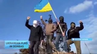 Resistance fighters burn militant's flag in Donetsk and fly Ukrainian flag