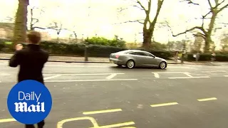 Silver Jaguar speeds away from parliament with police escort - Daily Mail