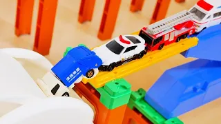 Various Working Cars Drive Down the Slope and Jump into a White BOX