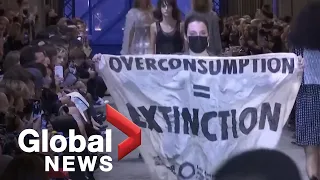 Climate protester sneaks onto Louis Vuitton catwalk at fashion show in Paris