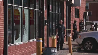 Two shot on Detroit's west side inside fish and chicken take-out restaurant