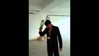 My student breaking glass bottle on his head live. Example