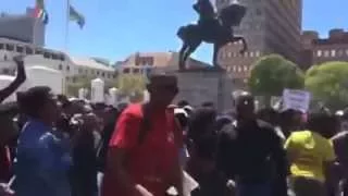 Protesting students arrive at Parliament in Cape Town, burn tyres