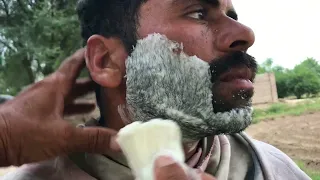 Old barber Shaving With Straight Razor and local soap