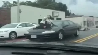 VIDEO: Road rage victim clings to hood of car