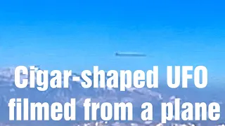 Cigar-shaped UFO OVNI filmed from a plane over Andes MUST SEE