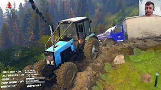 Blue tractor helping a truck