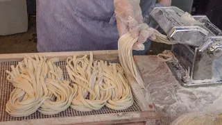 Italian Fresh Pasta,  Melted Cheese Wheel and Tomato. London Street Food