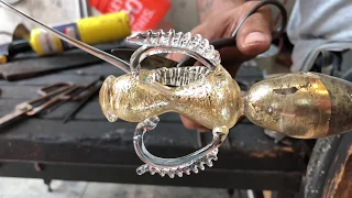 Glass artist Manolo Aguilera creates a traditional Venetian goblet with gold leaf